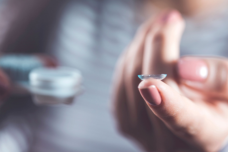 Person holding contact lens.