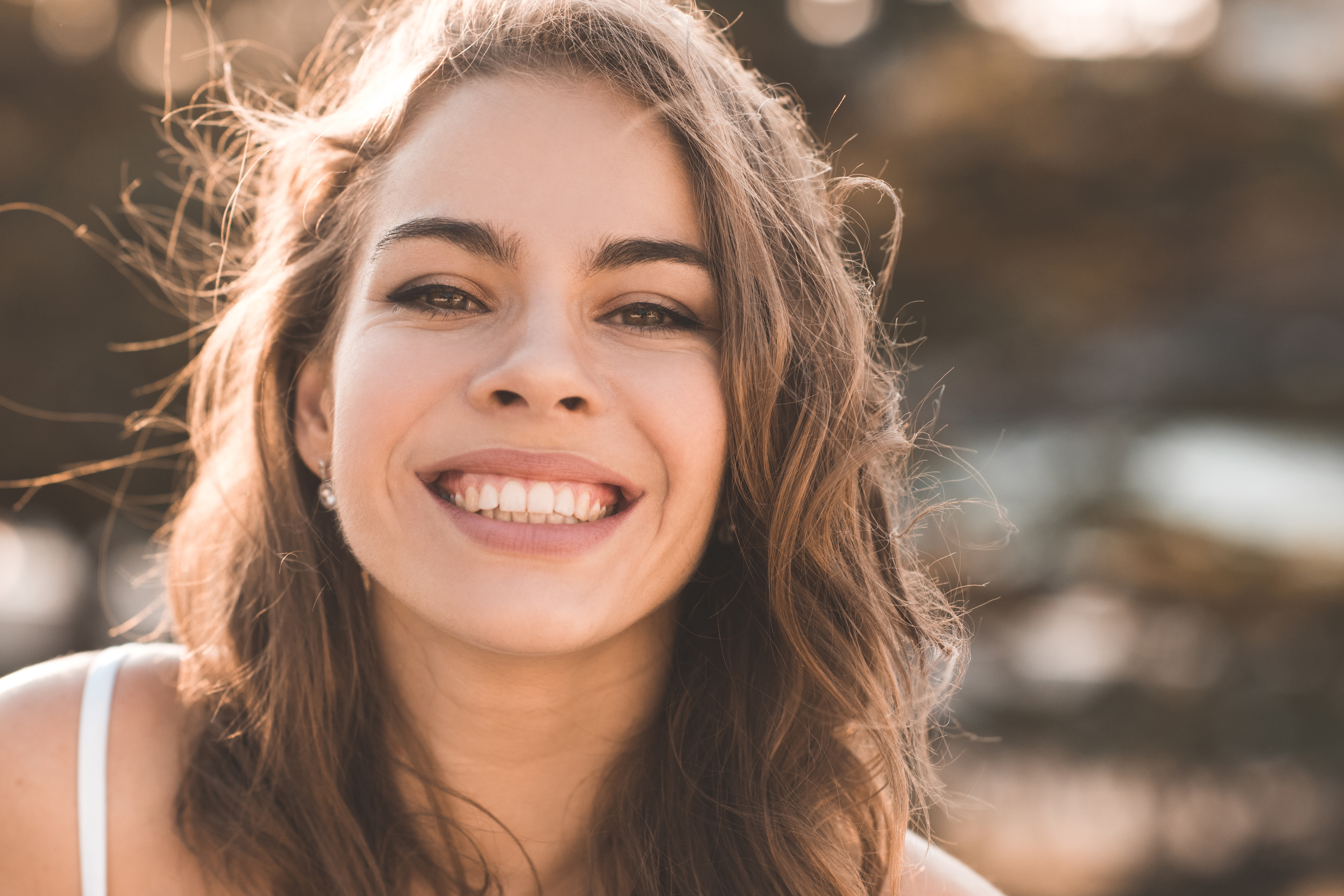 Smiling woman in a sunny outdoor setting
