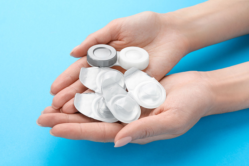 A picture of contact lenses on a pair of hands