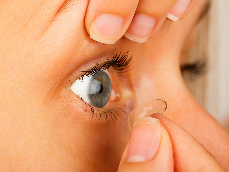 a picture of a woman removing contact lens
