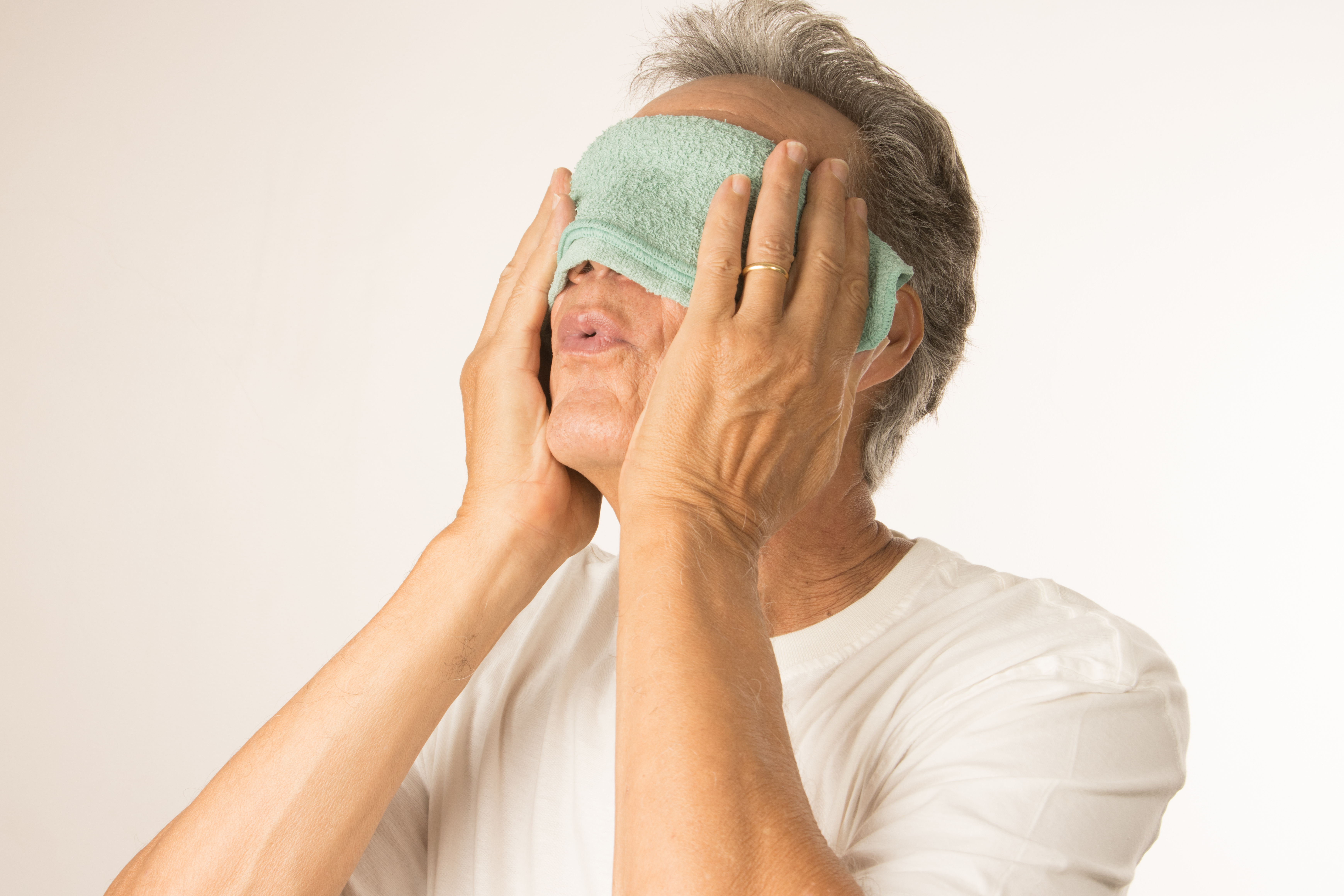 Man massaging her eyelids.