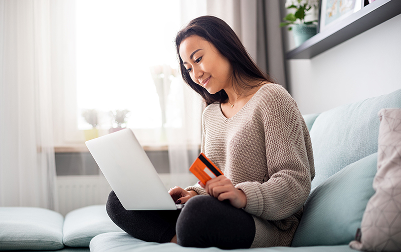 Woman making online payment using laptop for online shopping