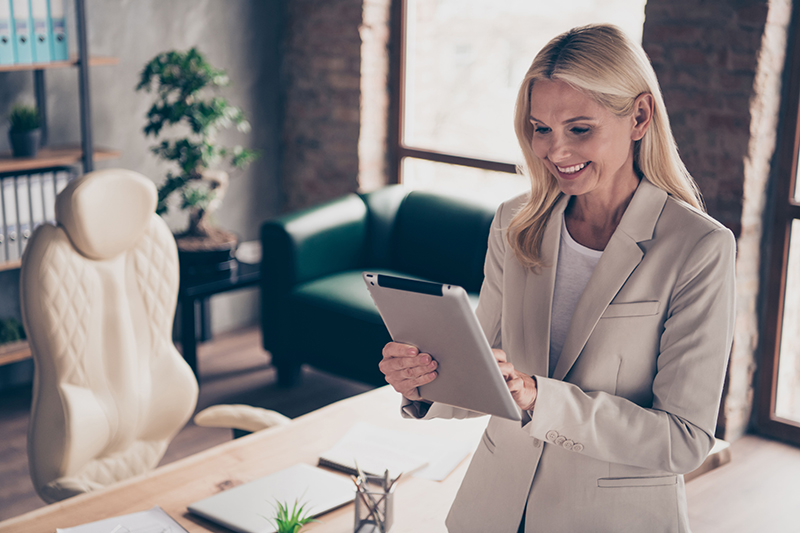 Woman using a tablet in the office.