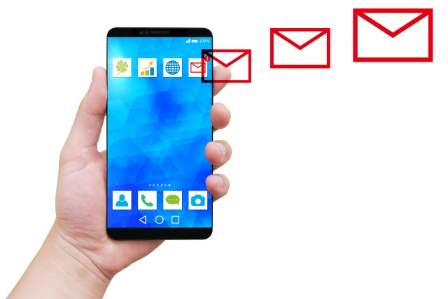 single hand holding android smartphone with blue screen, with 3 horizontally organized red email logo