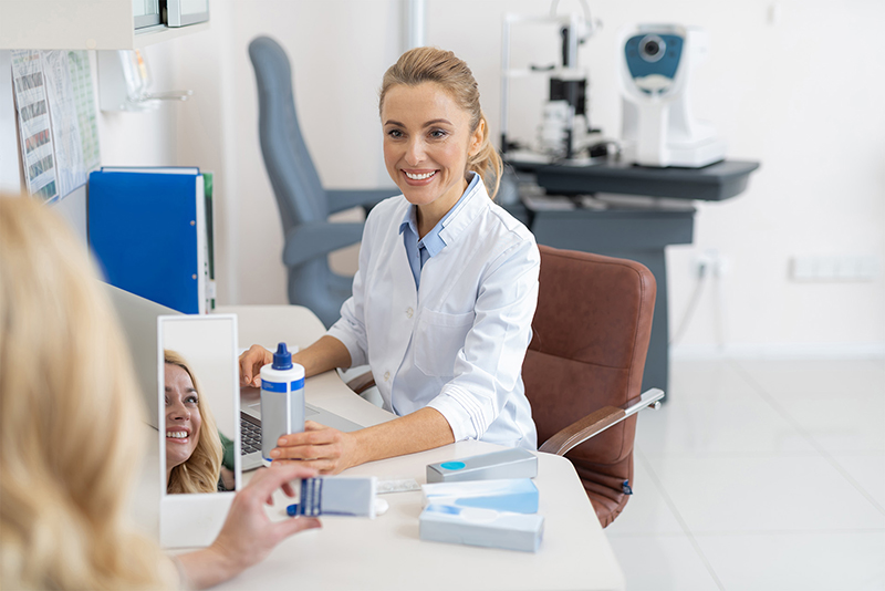 Eye doctor consulting a patient in exam room